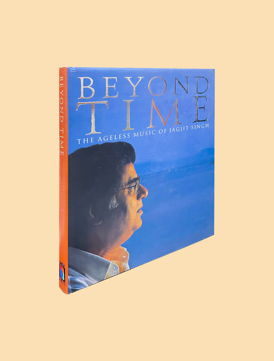 A boxed music release titled "Beyond Time: The Ageless Music of Jagjit Singh" shown at an angle on a plain warm beige background. The package features a blue cover with a side profile portrait and orange spine text.
