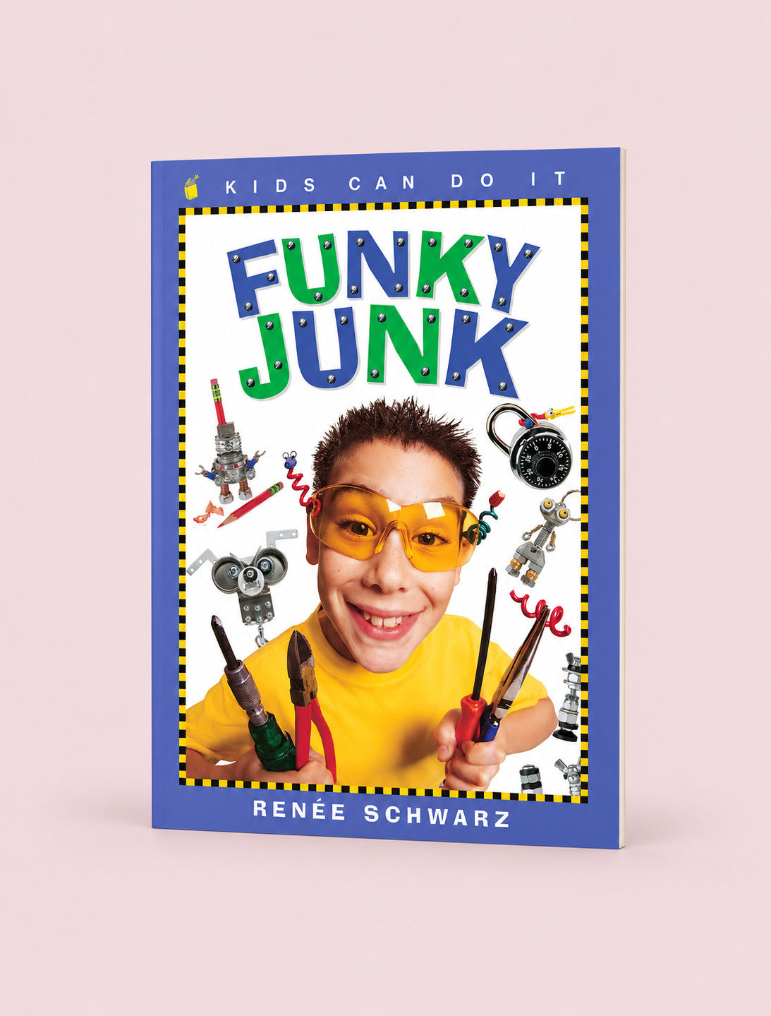 The book 'Funky Junk' by Renée Schwarz is shown standing upright on a light pink background. The cover features a bright blue border and a colorful illustration of a young boy wearing safety glasses and holding tools, surrounded by various junk items.