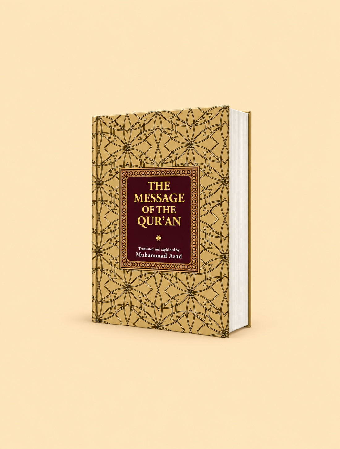 The Message of the Quran book by Muhammad Asad, featuring a gold geometric patterned cover with a dark red central label, shown on a solid beige background.