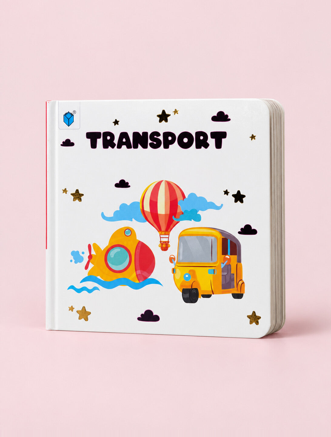 A children's hardcover book titled 'TRANSPORT' featuring colorful illustrations of a yellow auto-rickshaw, a red and yellow hot air balloon, a red submarine, and clouds on a white cover, set against a solid pink background.
