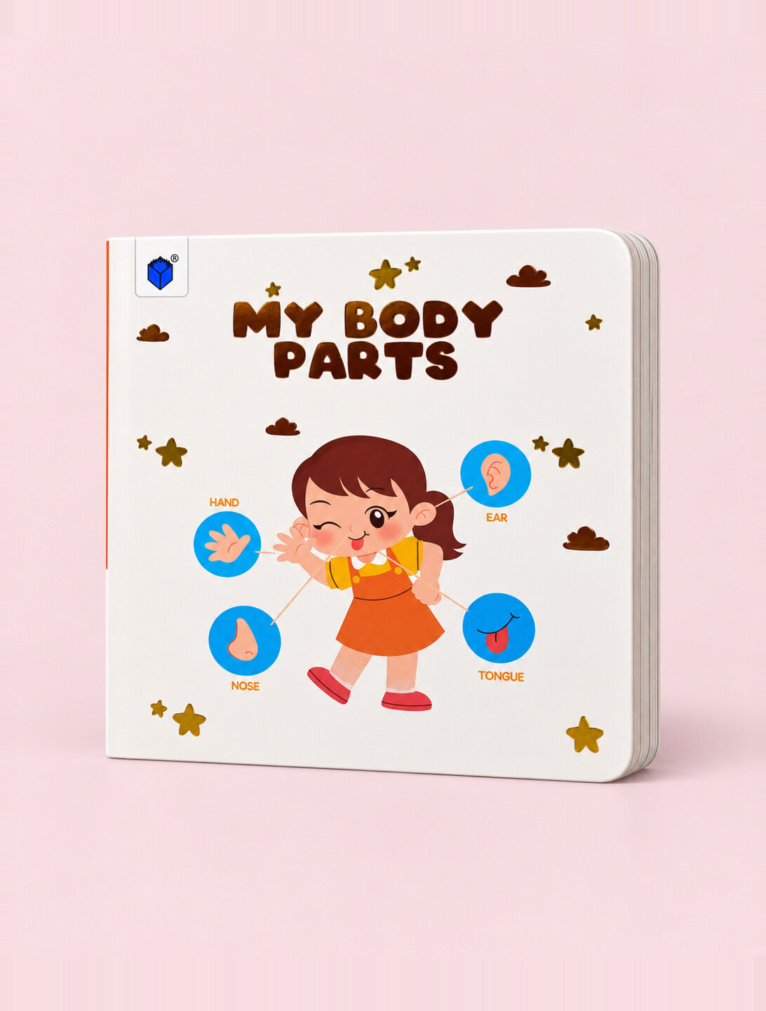 A children's educational book titled 'MY BODY PARTS' shown on a soft pink background. The book cover features a cartoon girl with a red dress and brown hair, surrounded by blue circular icons for hand, ear, foot, and tongue, along with brown clouds and gold stars.